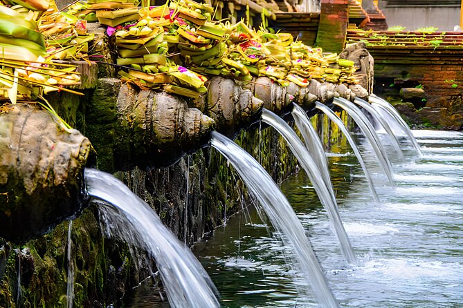 Ubud Bali: Rice Terrace, Waterfall and Tirta empul Day Tour - Kanto Lampo waterfall: stone views, real spray, and photo time